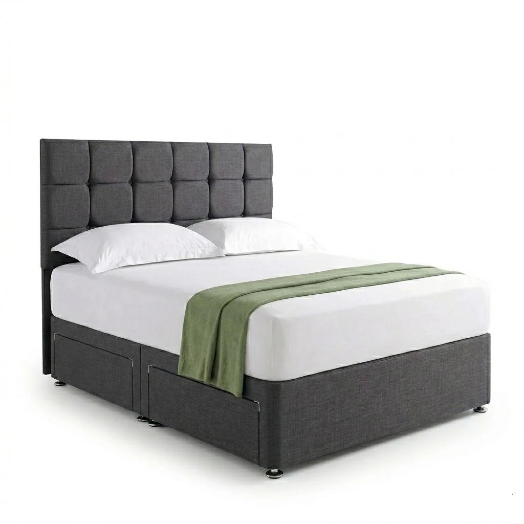Gray upholstered bed with white bedding and a green blanket on a white background