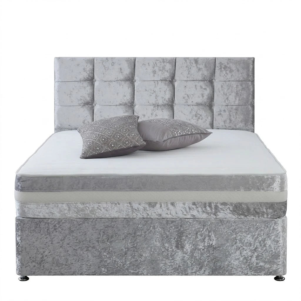 Gray upholstered bed with tufted headboard and two pillows on a white background