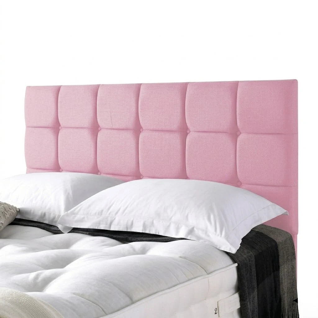 Pink tufted headboard with white pillows and a gray blanket on a white background