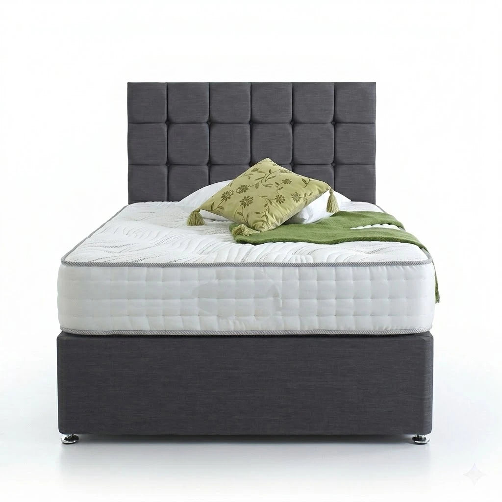 Gray upholstered bed with white mattress and green blanket and pillow on a white background