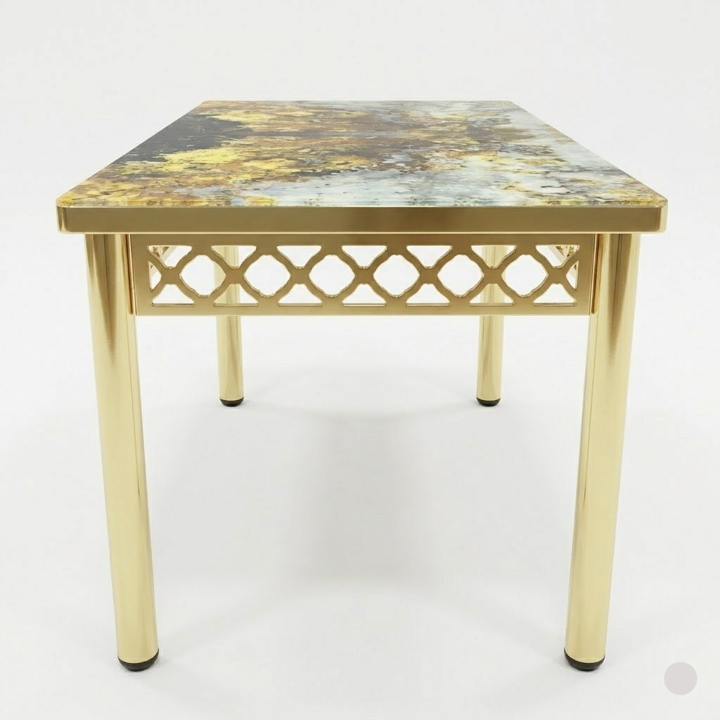Small table with gold legs and a patterned top on a white background