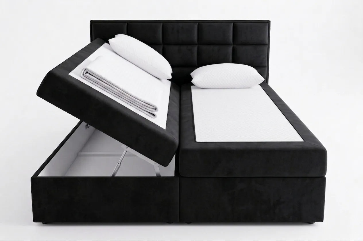 Black upholstered bed with storage compartments on a white background