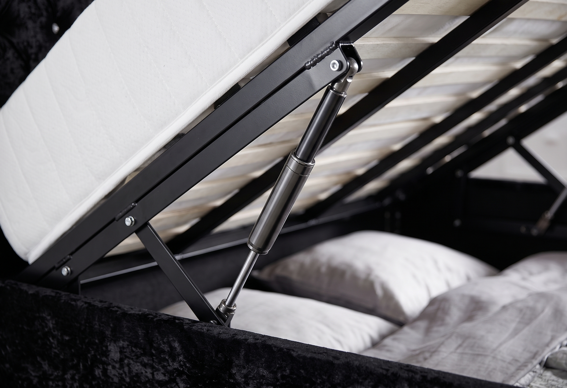 Close-up of a adjustable bed mechanism with mattress and pillows.