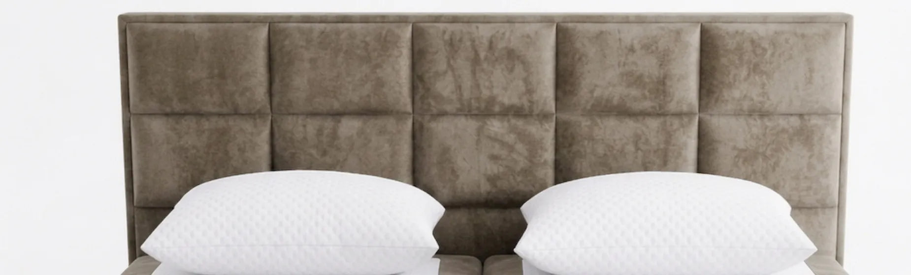 Brown upholstered headboard with two white pillows on a white background