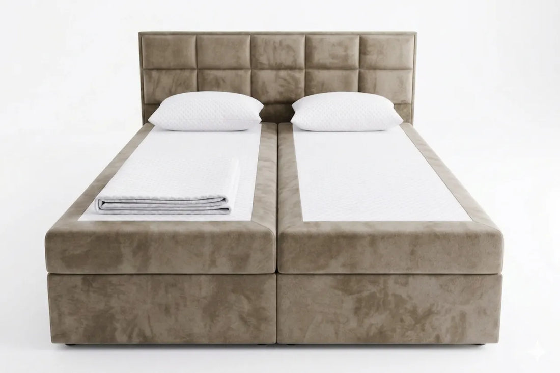 Beige upholstered bed with white bedding on a white background