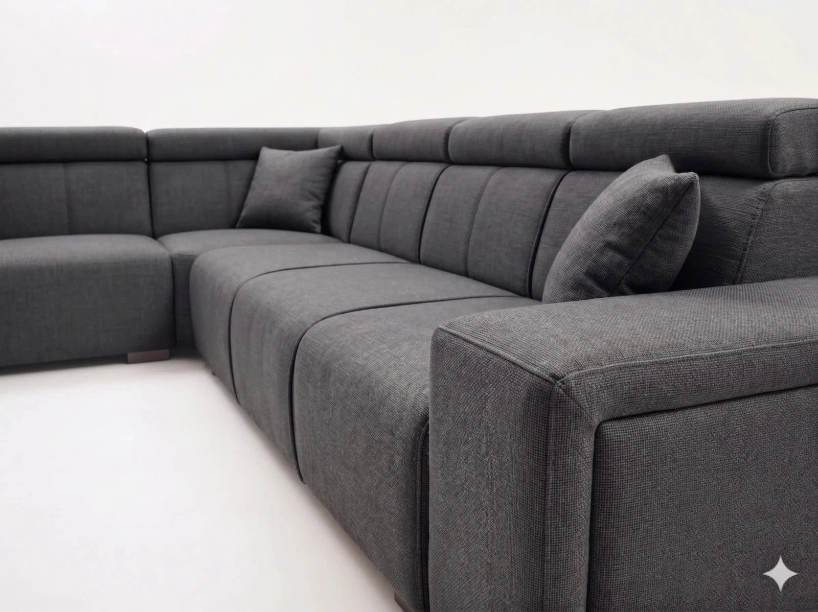 Gray sectional sofa with cushions on a white background