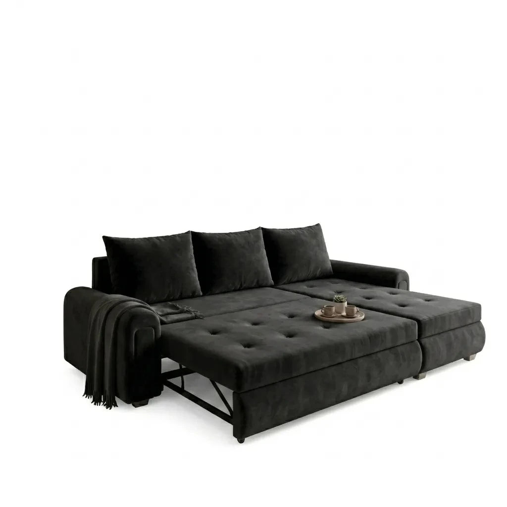 Black sectional sofa with ottoman on a white background