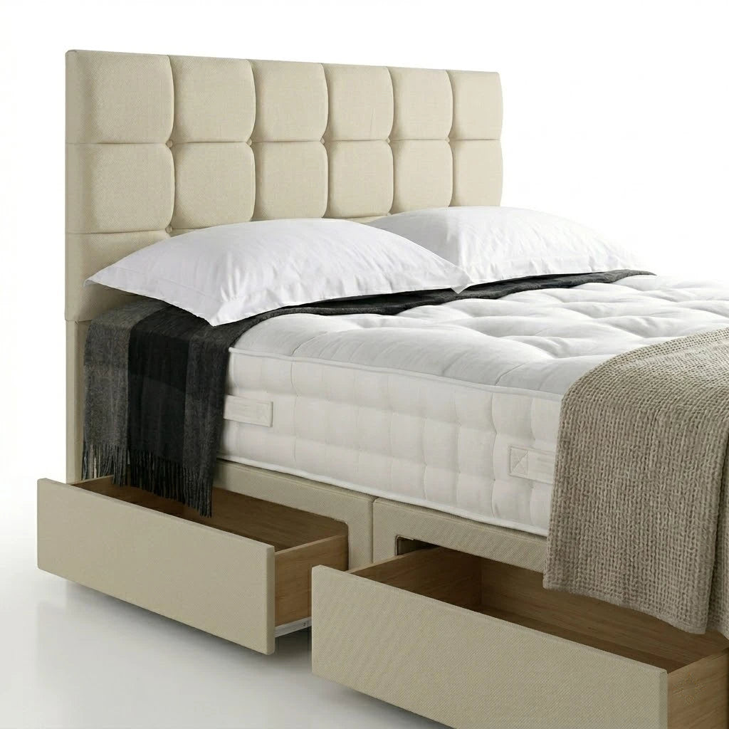 Beige upholstered bed with storage drawers and white bedding on a white background
