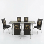Dining table set with black chairs featuring pumpkin design on a white background