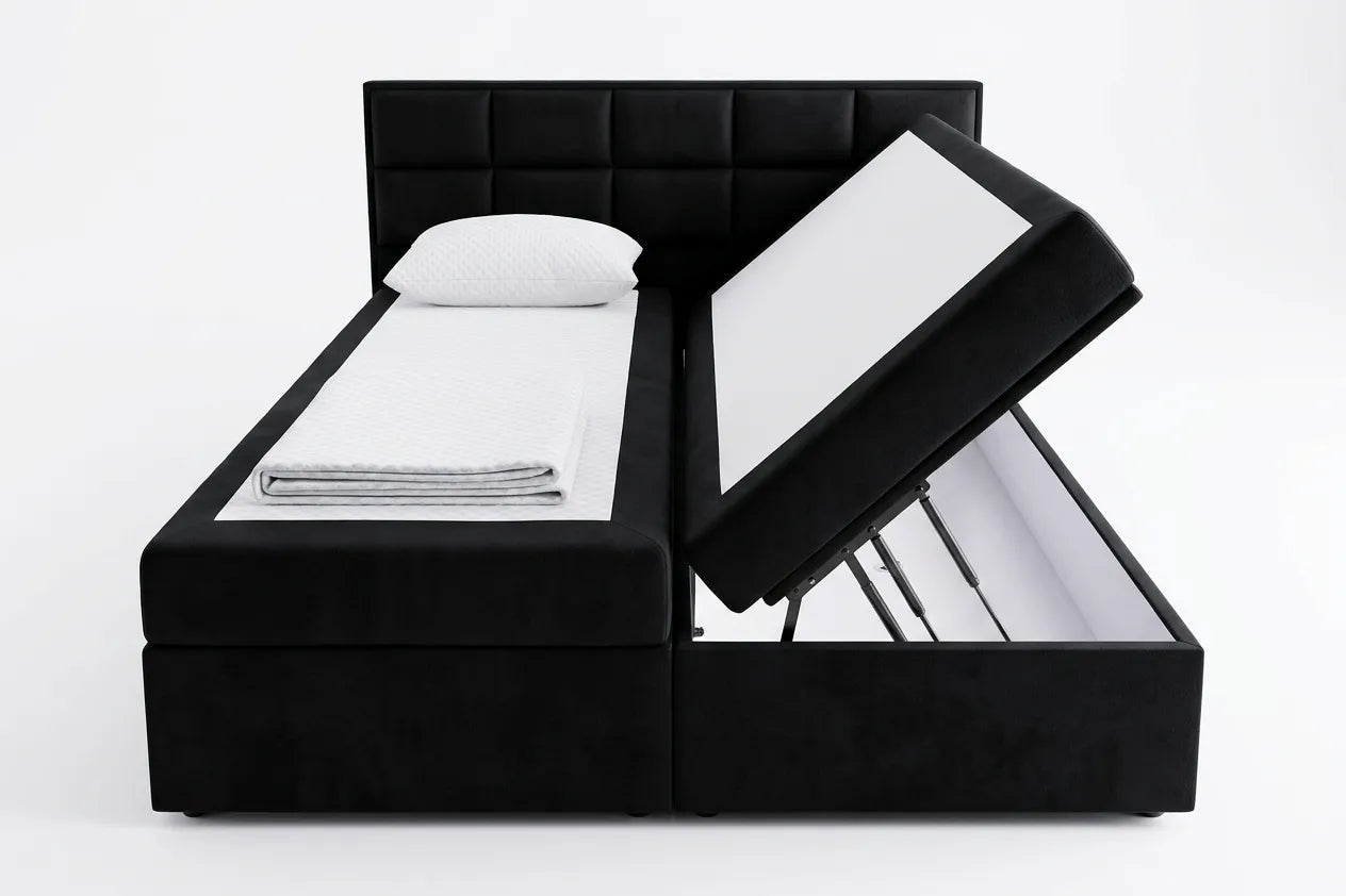 Black upholstered bed with open storage drawers on a white background